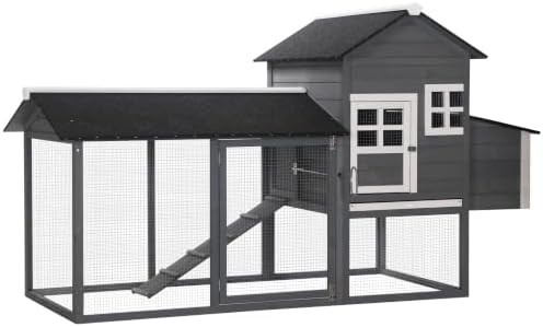 Two story gray wooden coop with run